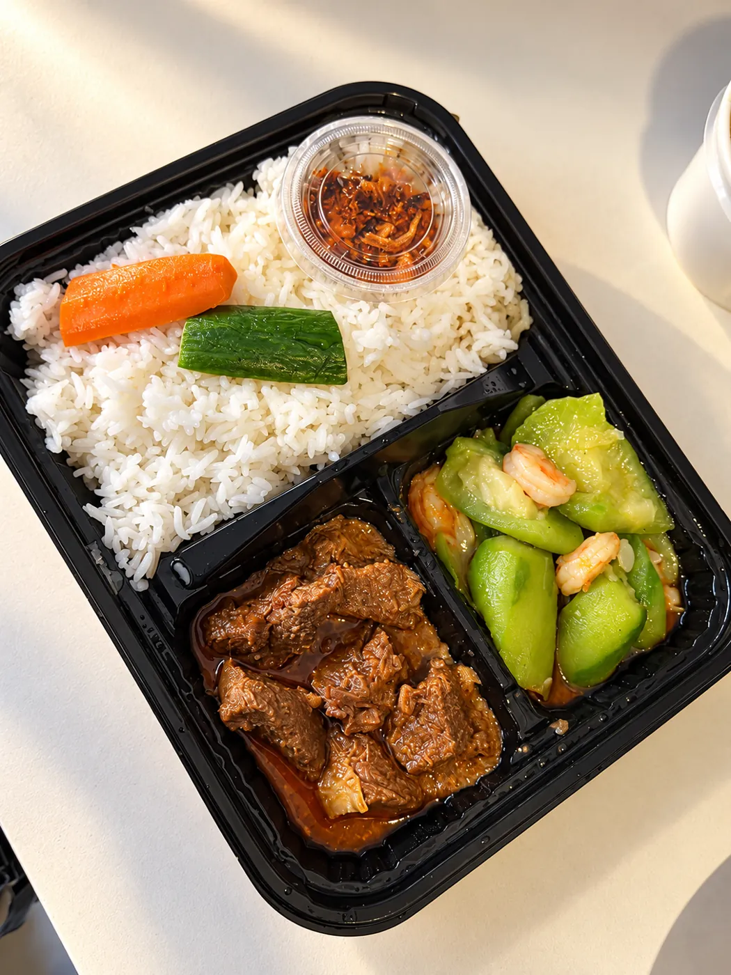 Combo tray with beef, shrimp and vegetables, white rice and a side cup